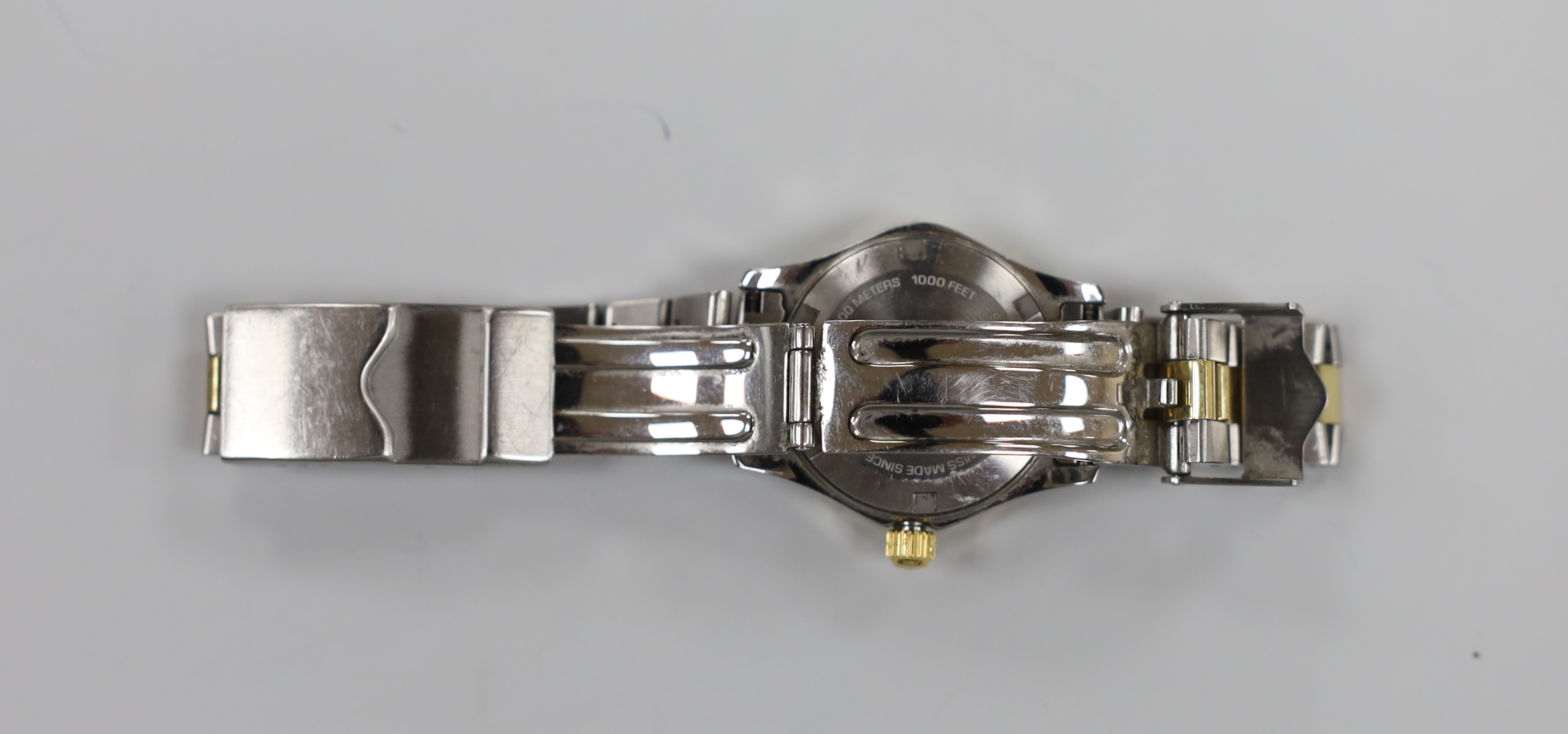 A lady's modern steel and gold plated Tag Heuer Aquaracer quartz wrist watch, with mother of pearl dial, no box or papers, with spare link.